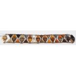 19th Century rose gold bracelet set with two rows of triangular carved lava masks, length 18cm (