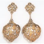 Pair of Victorian silver gilt ornate cast and pierced spoons, the finials with mask and ribbon