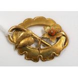 19th Century gold openwork brooch applied with a flower set with coral in the centre 52mm x 40mm,