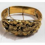 19th Century French 18ct gold bangle applied with pierced, cast & chased fruiting vine, the bracelet