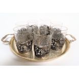 Continental white metal nine piece Schnapps set, comprising a set of eight glasses with silver