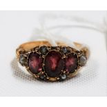 Victorian 15ct gold pink stone & pearl set ring, the largest oval cut ruby of 0.50ct spread approx &