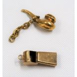 Two 9ct gold charms, one in the form of a hinge-lidded pike, the other a whistle, weight 2.3g