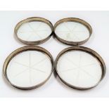 Set of four glass star cut coasters with silver rims.