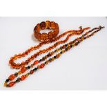 A multicoloured 'amber' style graduated bead necklace, length 65cm; together with another 'amber'