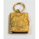 Victorian yellow metal book locket hinged to reveal three double-sided photograph pages, the