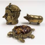 Three brass vesta cases, one in the form of a tortoise, the other a devil, and a pig.