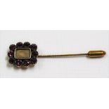 A stick pin with gold finial with purple paste stones & glazed hair panel