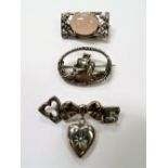 Victorian silver brooch in the form of a key and ribbon knot, with heart shaped drop inset a