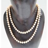 Long pearl necklace with 14ct gold Chinese emblem clasp, length 88cm.