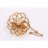 Modern yellow metal pearl set openwork brooch with safety chain, weight 5g approx