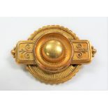 Victorian gold target brooch with central dome, the back with glazed panel, width 45mm weight 8.9g
