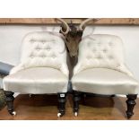 Pair of Victorian button back upholstered nursing chairs with turned forelegs and brass caps with
