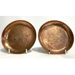 Pair of Newlyn copper circular dishes with hammered decoration of a fish '.H.R.S.C. 3RD' for Helford
