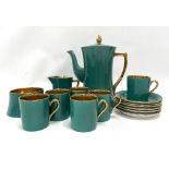 A Carlton Ware green and gilt glazed coffee set for six.