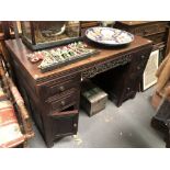 Chinese hardwood twin pedestal desk, the rectangular top with moulded edge over the pedestals with