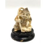 Japanese porcelain simulating ivory figure of a fisherman upon ebonised stand, height of figure 4.
