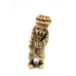 A Japanese bone netsuke, carved as a sage, length 5.5cm.