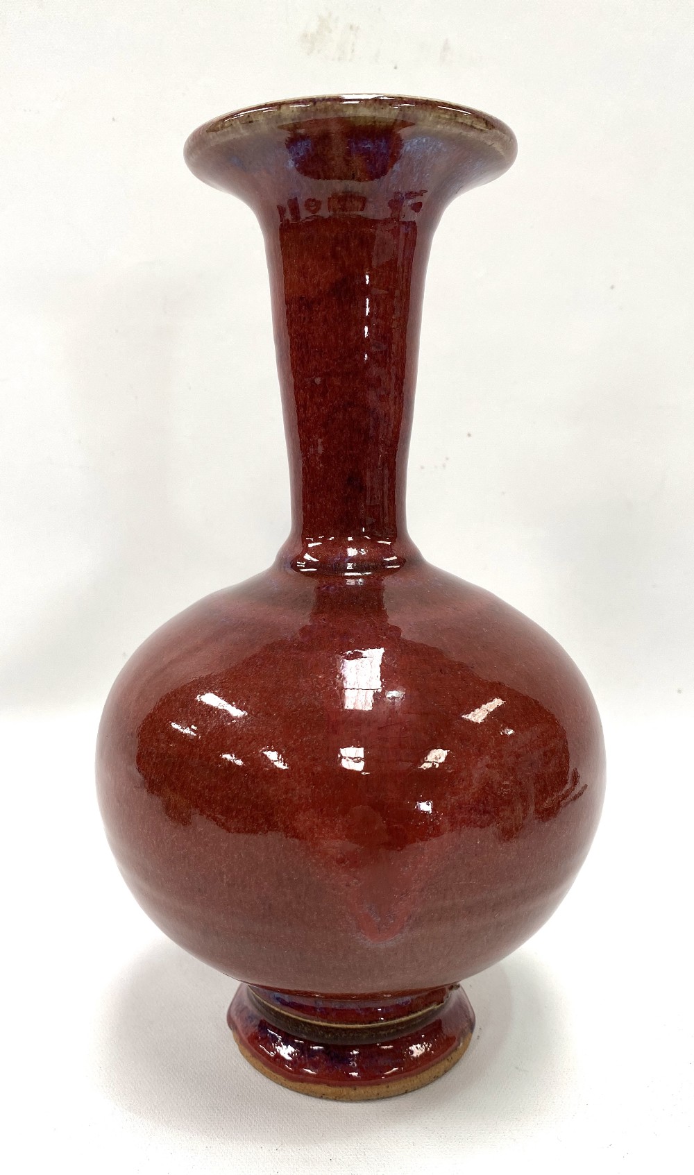 A Chinese stoneware sang de boeuf glaze flared neck bottle vase, height 25cm.