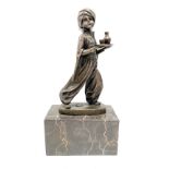A bronze sculpture of an Arab boy holding a tray after Preiss upon a black and white veined
