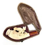 A cased meerschaum cheroot pipe with amber mouthpiece, the pipe carved with a fox, within fitted