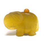 A Chinese carved yellow hard stone elephant snuff bottle and stopper, width 6cm.