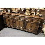 Good reproduction oak dresser base, the moulded top over three carved drawers and three panelled