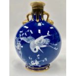 A Victorian Mintons pate-sur-pate moon flask decorated with a stork in flight amongst prunus blossom