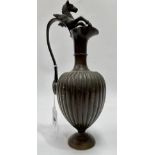 A bronze Neo Classical style pedestal ewer with ovoid fluted body, the scroll handle with Pegasus