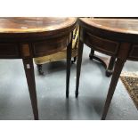 Matched pair of George III mahogany cross banded and inlaid demi-lune card tables, both hinged to