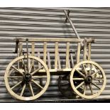 Wooden ironed framed dog cart, possibly Victorian, length from wheel to wheel 106cm.