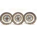 A set of three 18th century polychrome Delft dishes, each painted with a flower to the centre,