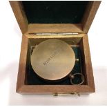 A brass pocket compass by Ross, London, diameter 4.5cm, within hinged stained box.