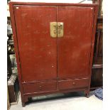 Modern Chinese red painted cupboard with curved doors enclosing shelves and an open back, the base