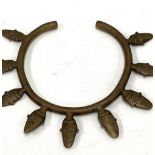 An African tribal brass torc cast with nine heads.