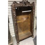 Late 19th Century carved oak continental bookcase, with glazed door, the carved surmount with hounds