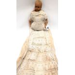 19th Century wax head & limb doll, the head with remnants of blonde hair & with glass inset eyes,