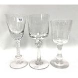 Three modern large wine glasses, one with air twist stem, all with etched decoration depicting