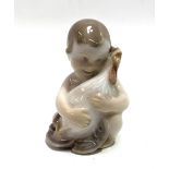 A small Royal Copenhagen figure of a boy hugging a chicken, No.2445, height 6cm.