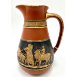 A Torquay terracotta jug printed and gilded with a band of classical figures on chariots, stamped