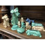 Eleven various Sylvac Pottery dog figures; together with two hat wall pockets.