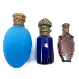 Three 19th century coloured glass metal mounted scent bottles, the largest length 6.5cm.