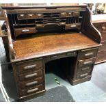 Early 20th Century oak tambour roll top desk, width 138cm.