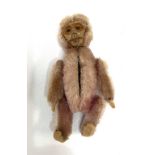 An early 20th century Schuco pink mohair miniature monkey rouge compact holder, height 9cm.