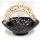 An African carved hippopotamus tusk and ebony handled bowl, the hippopotamus tusk handle carved