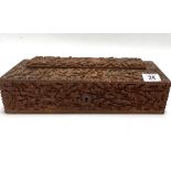 An Indian carved teak rectangular hinge lidded stationery box, with caddy top, the whole profusely