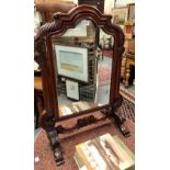 Victorian mahogany swivel toilet mirror, the shaped mirror within a foliate carved shaped frame