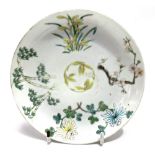 A Chinese famille verte celadon saucer dish, foliate decorated, red seal mark to the base,