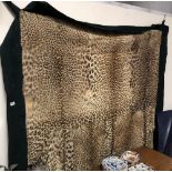 Antique leopardskin rug with green baize backing, 190cm x 198cm