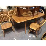 Ercol pale elm rectangular drop leaf extending dining table; together with a set of four stick